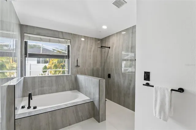 a bathroom with a tub and a shower