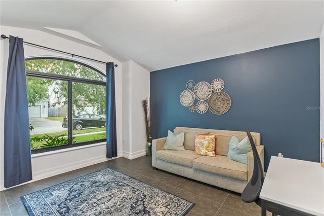 a living room with couch and a large window