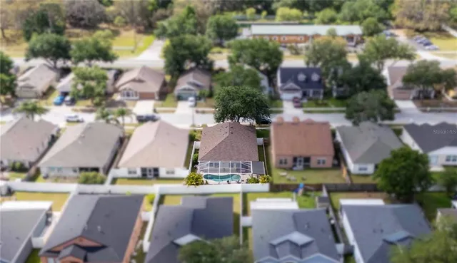 an aerial view of multiple houses with yard
