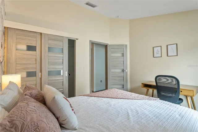 a bedroom with a bed and a chair