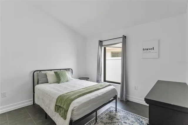 a bedroom with a bed and a desk