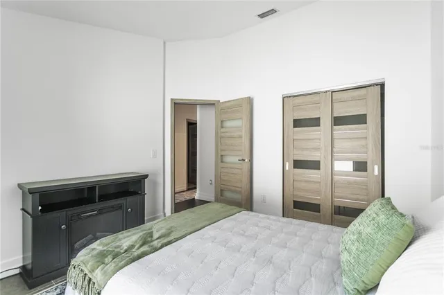 a bedroom with a bed and a television