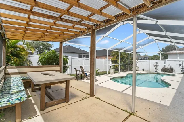 a view of a patio with table and chairs and potted plants