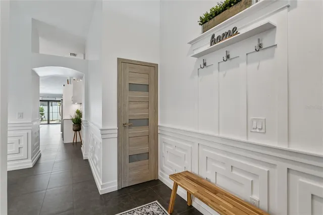 a view of a hallway with closet and a couch