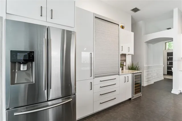 a kitchen with stainless steel appliances a refrigerator and cabinets