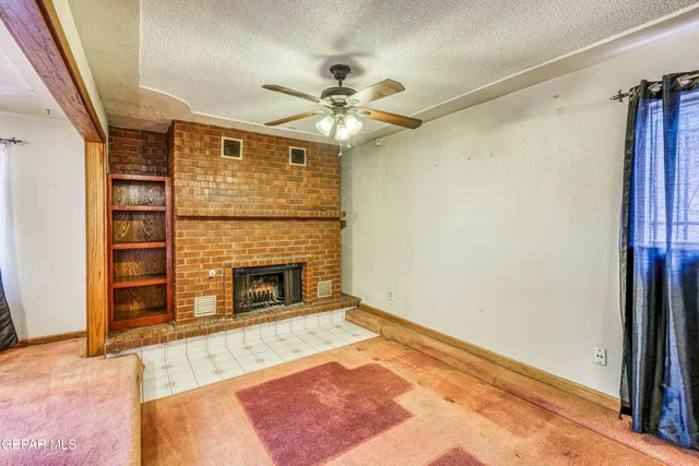 a kitchen with granite countertop a sink and a stove next to a window