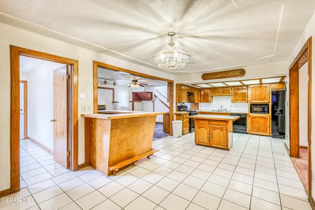 a kitchen with stainless steel appliances granite countertop a stove and a refrigerator