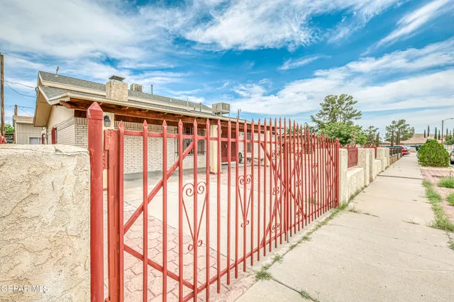 a view of a hallway with wooden floor and a kitchen