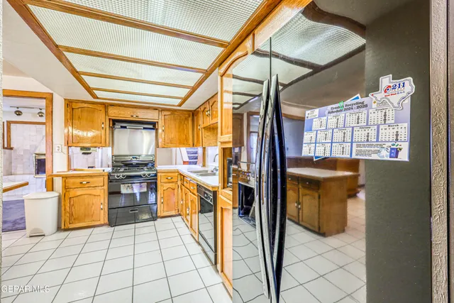 a front view of a house with a garden and trees