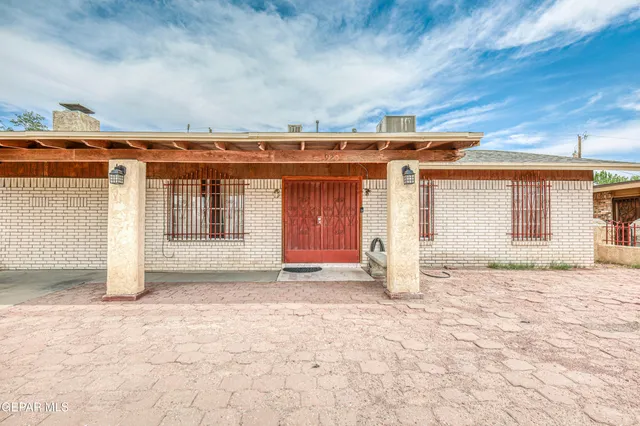a view of kitchen with granite countertop cabinets and refrigerator