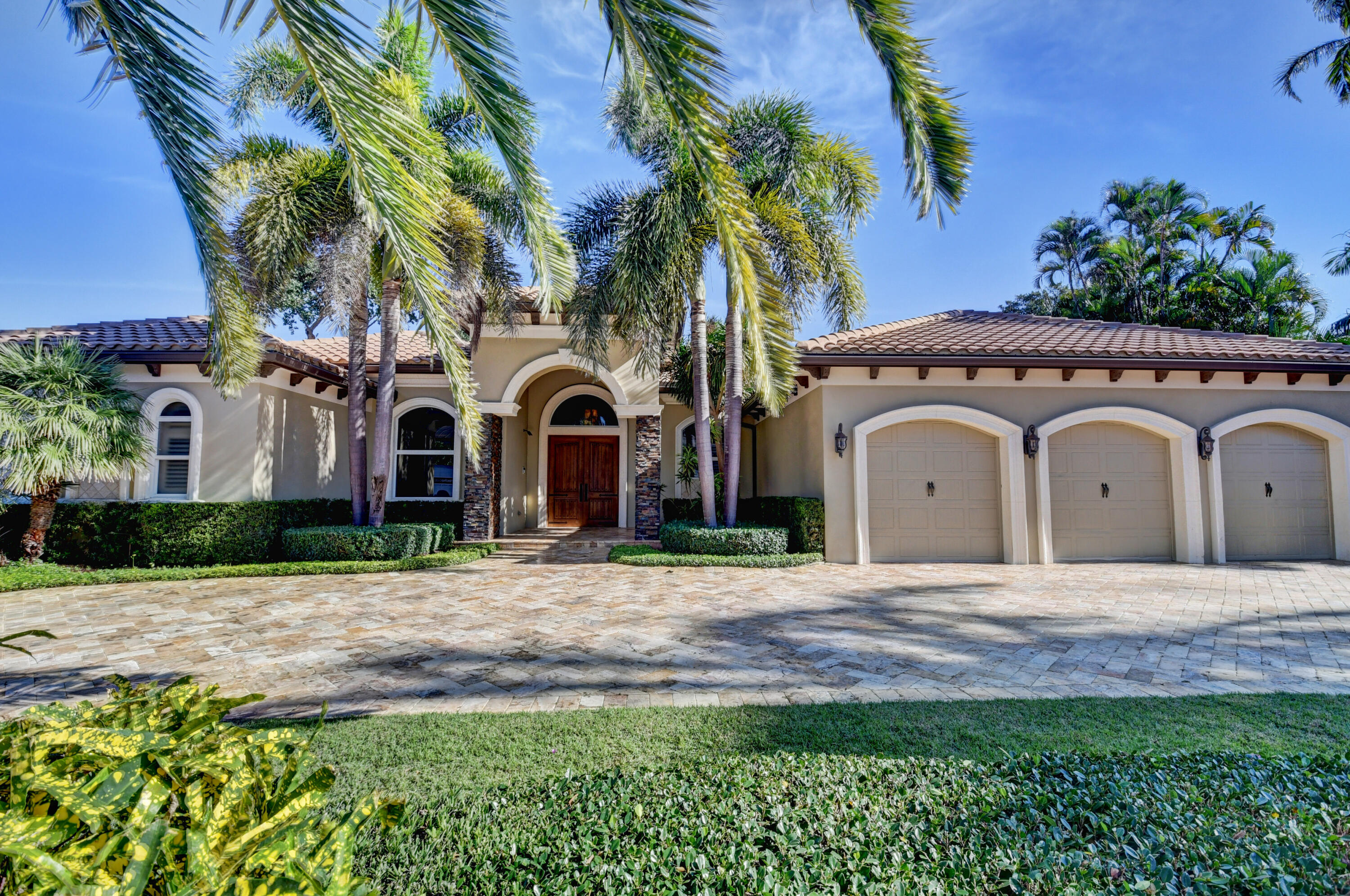 1130 Spanish River Road Boca Raton, FL 33432 - Photo 1 of 59 a view of a white house with a small yard and plants