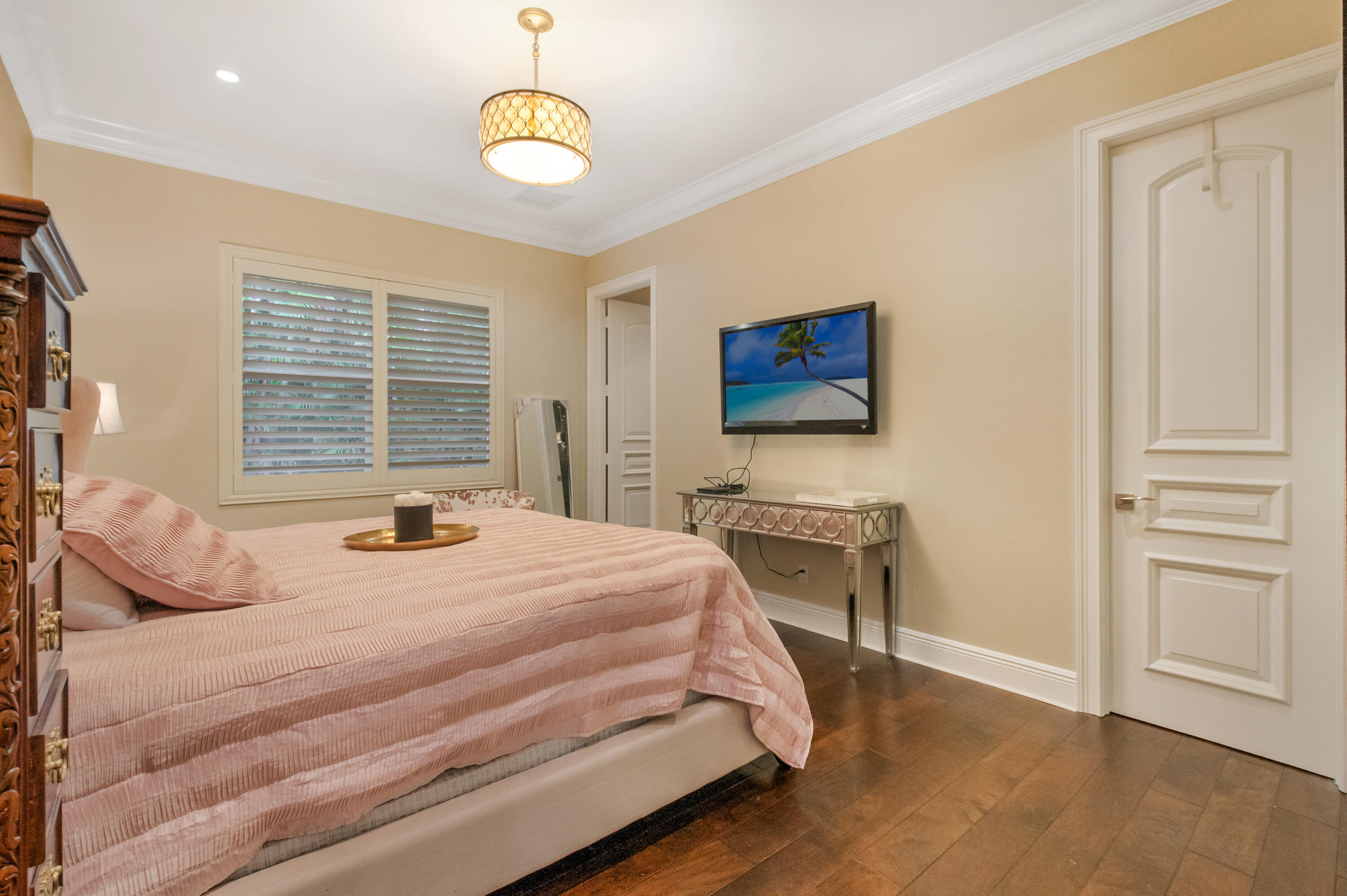 1130 Spanish River Road Boca Raton, FL 33432 - Photo 14 of 59 a bedroom with a bed and a chandelier