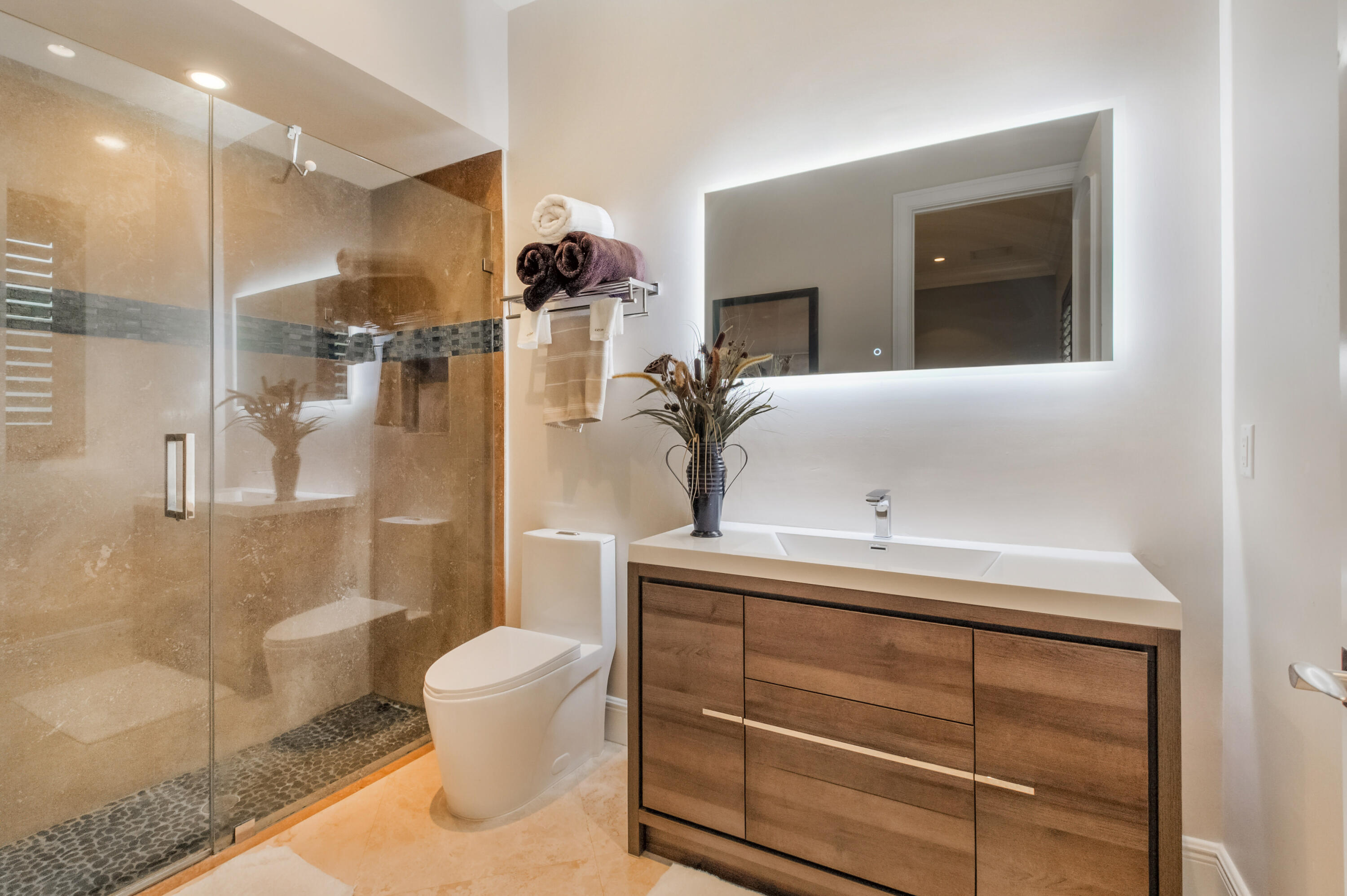 1130 Spanish River Road Boca Raton, FL 33432 - Photo 16 of 59 a bathroom with a sink a toilet and shower