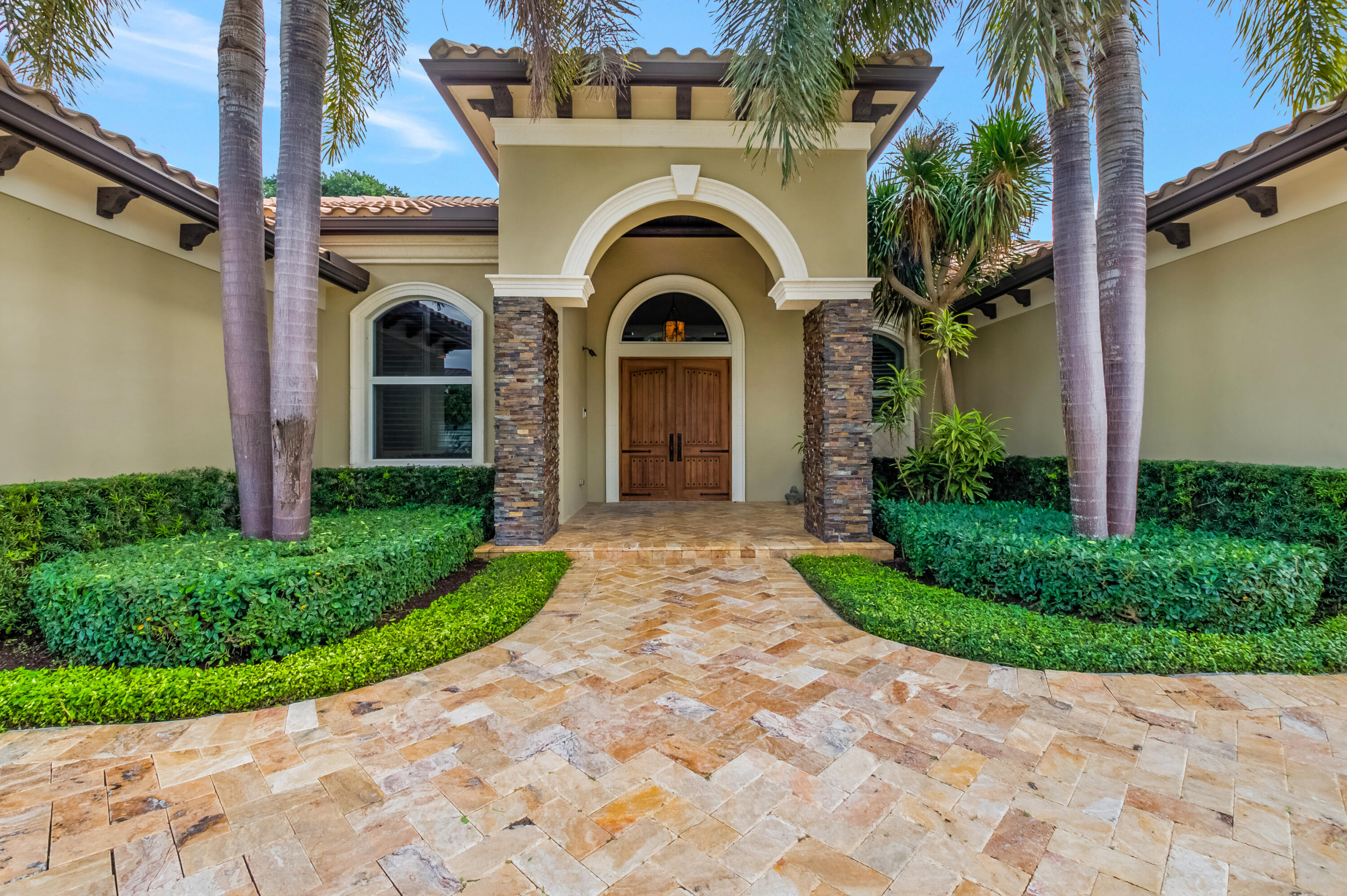1130 Spanish River Road Boca Raton, FL 33432 - Photo 2 of 59 a view of a house with a small garden