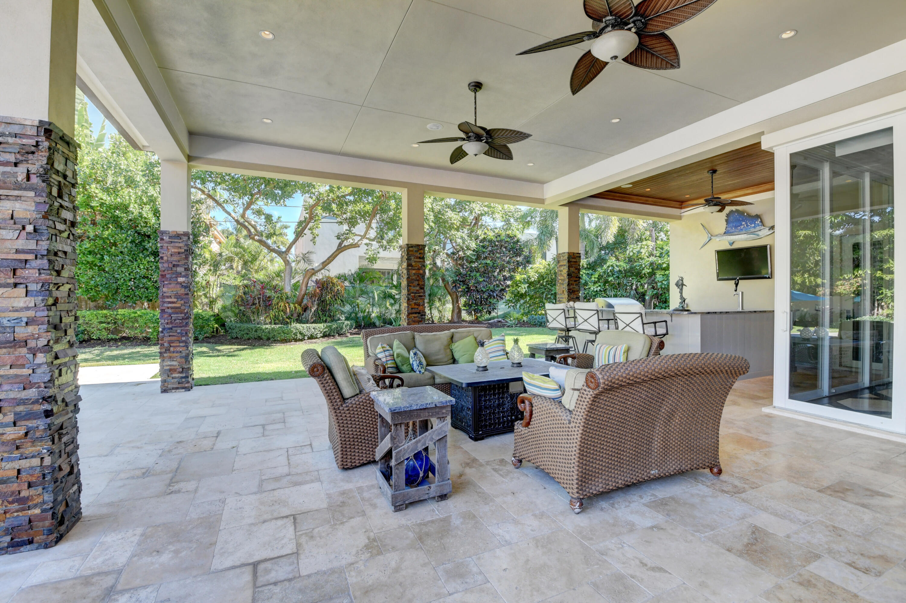 1130 Spanish River Road Boca Raton, FL 33432 - Photo 22 of 59 a living room with patio furniture and a floor to ceiling window