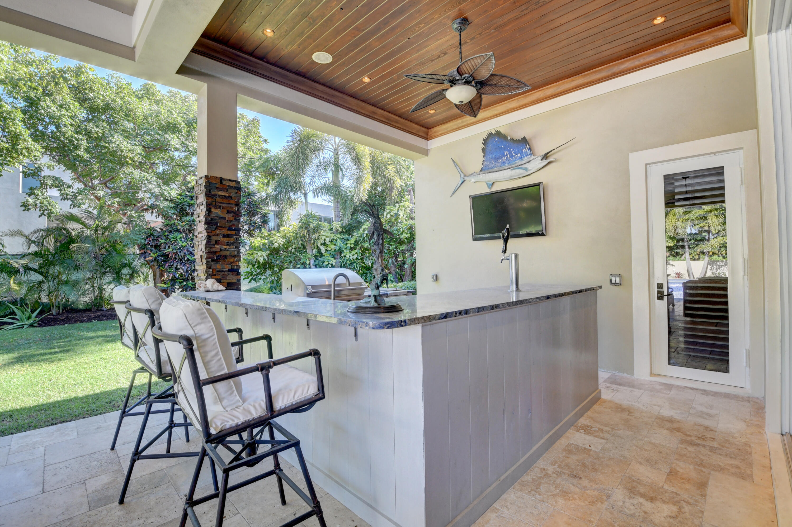 1130 Spanish River Road Boca Raton, FL 33432 - Photo 27 of 59 a living room with patio furniture and a flat screen tv