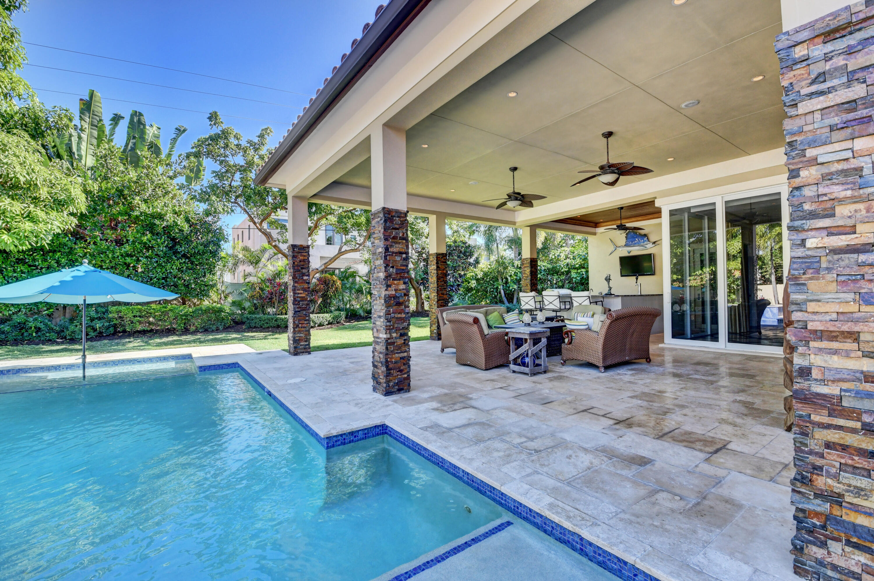 1130 Spanish River Road Boca Raton, FL 33432 - Photo 35 of 59 a view of a patio with table and chairs under an umbrella