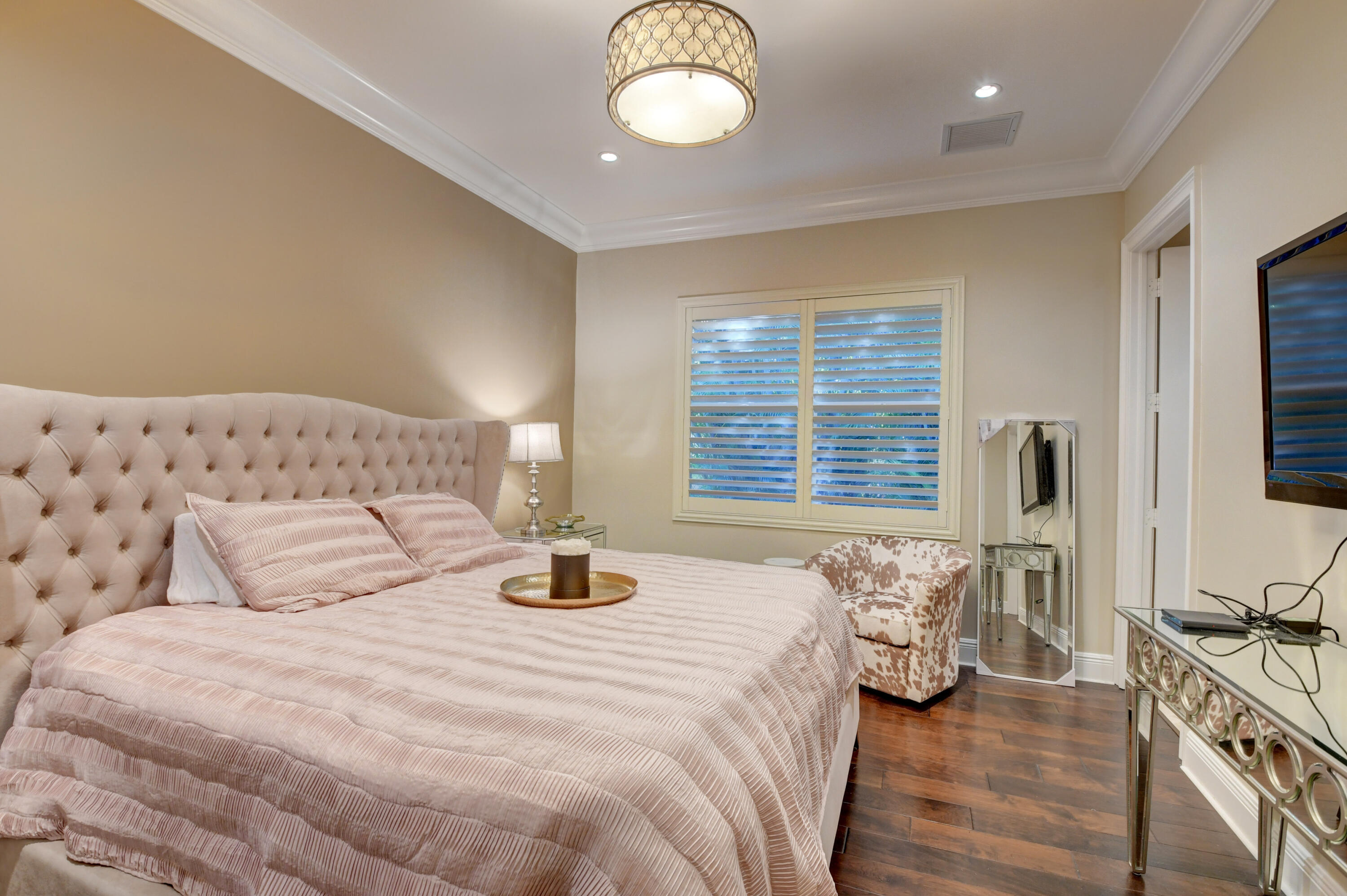 1130 Spanish River Road Boca Raton, FL 33432 - Photo 47 of 59 a bedroom with a bed and a flat tv screen