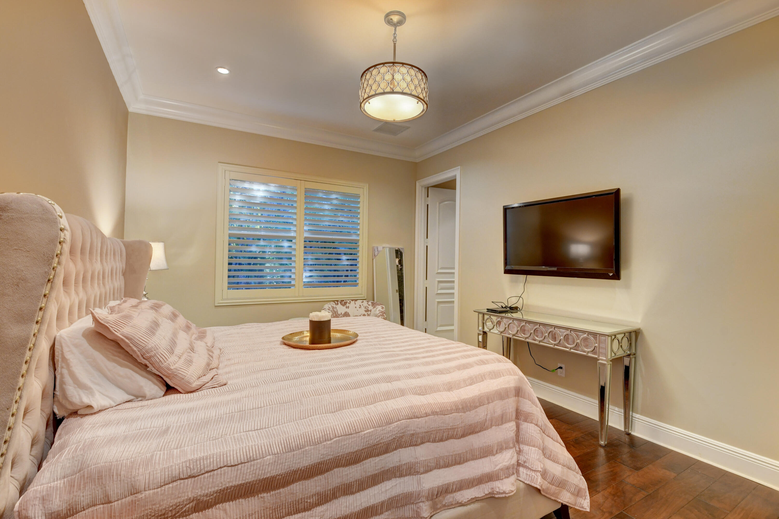 1130 Spanish River Road Boca Raton, FL 33432 - Photo 48 of 59 a bedroom with a bed and a flat screen tv