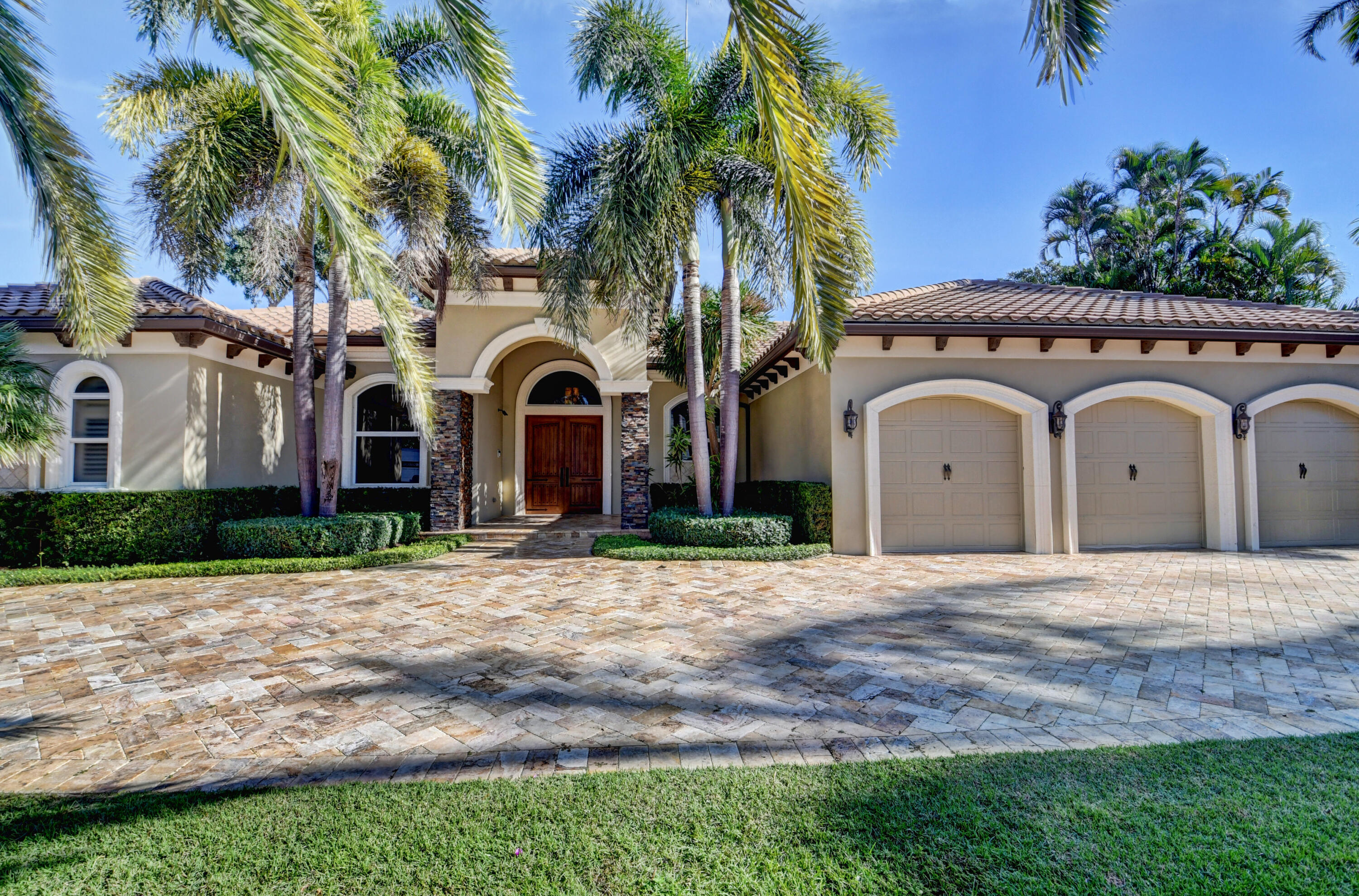 1130 Spanish River Road Boca Raton, FL 33432 - Photo 51 of 59 a front view of a house with a garden
