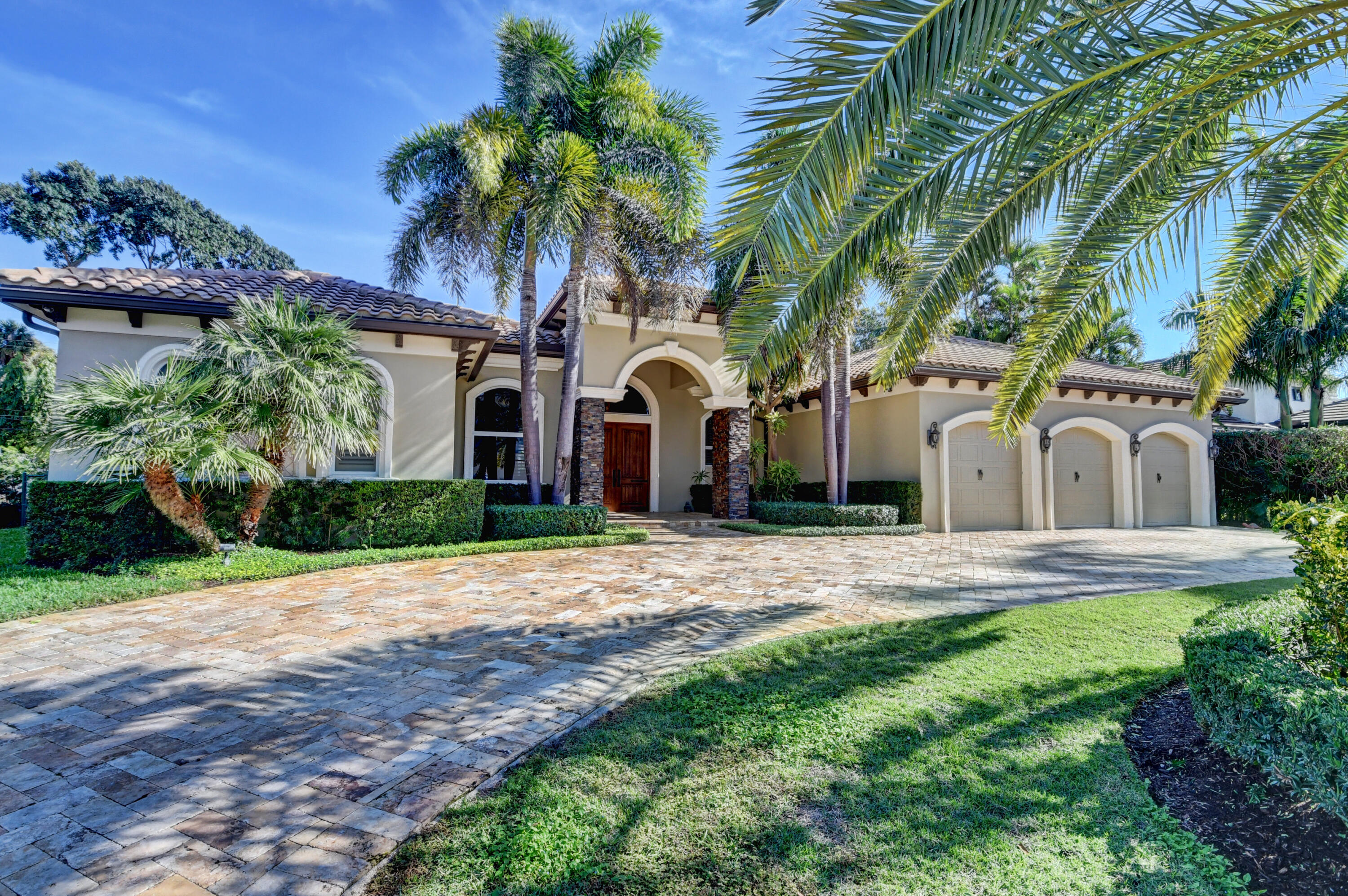 1130 Spanish River Road Boca Raton, FL 33432 - Photo 52 of 59 a front view of a house with garden