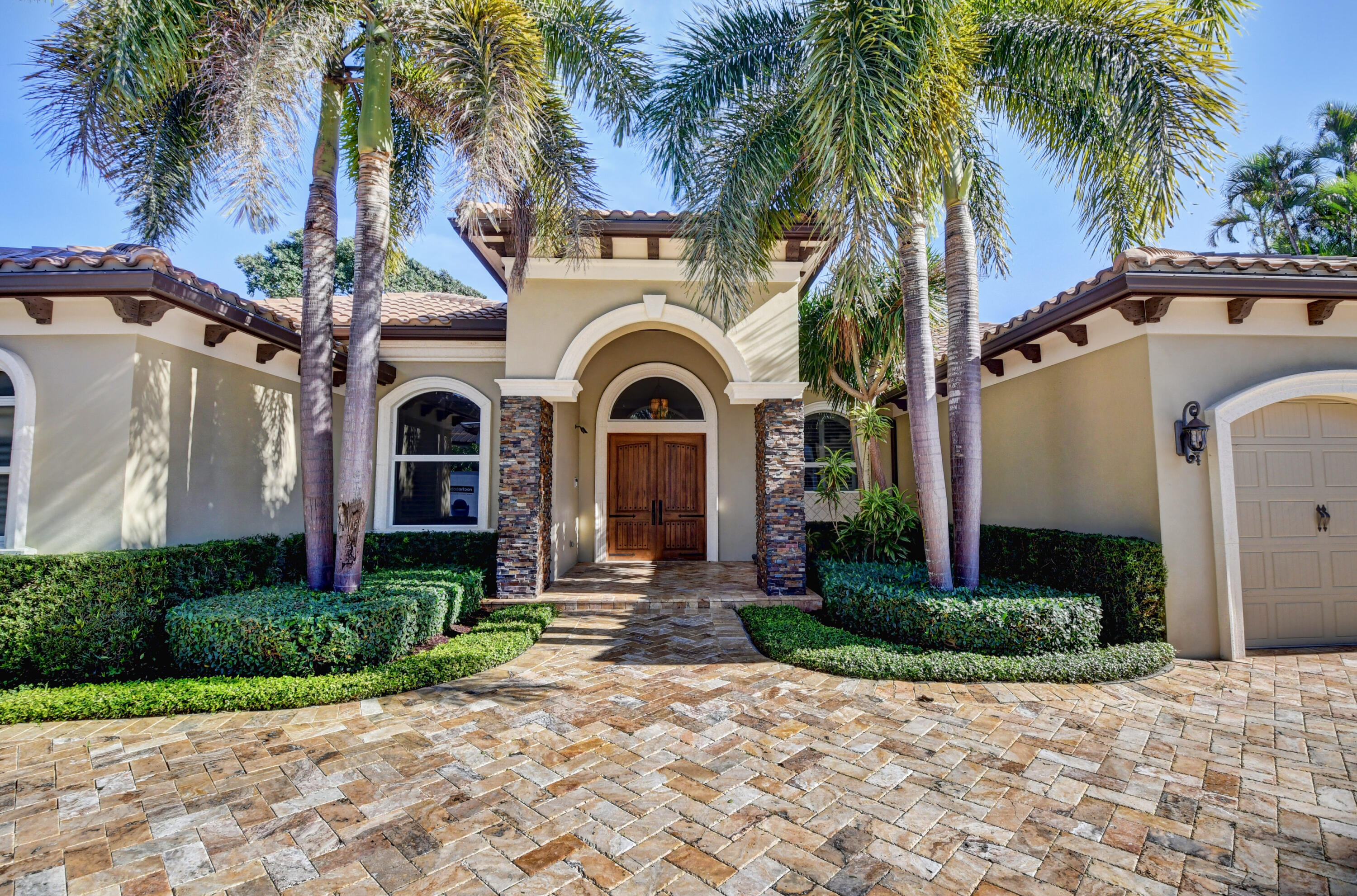 1130 Spanish River Road Boca Raton, FL 33432 - Photo 54 of 59 a front view of a house with a garden