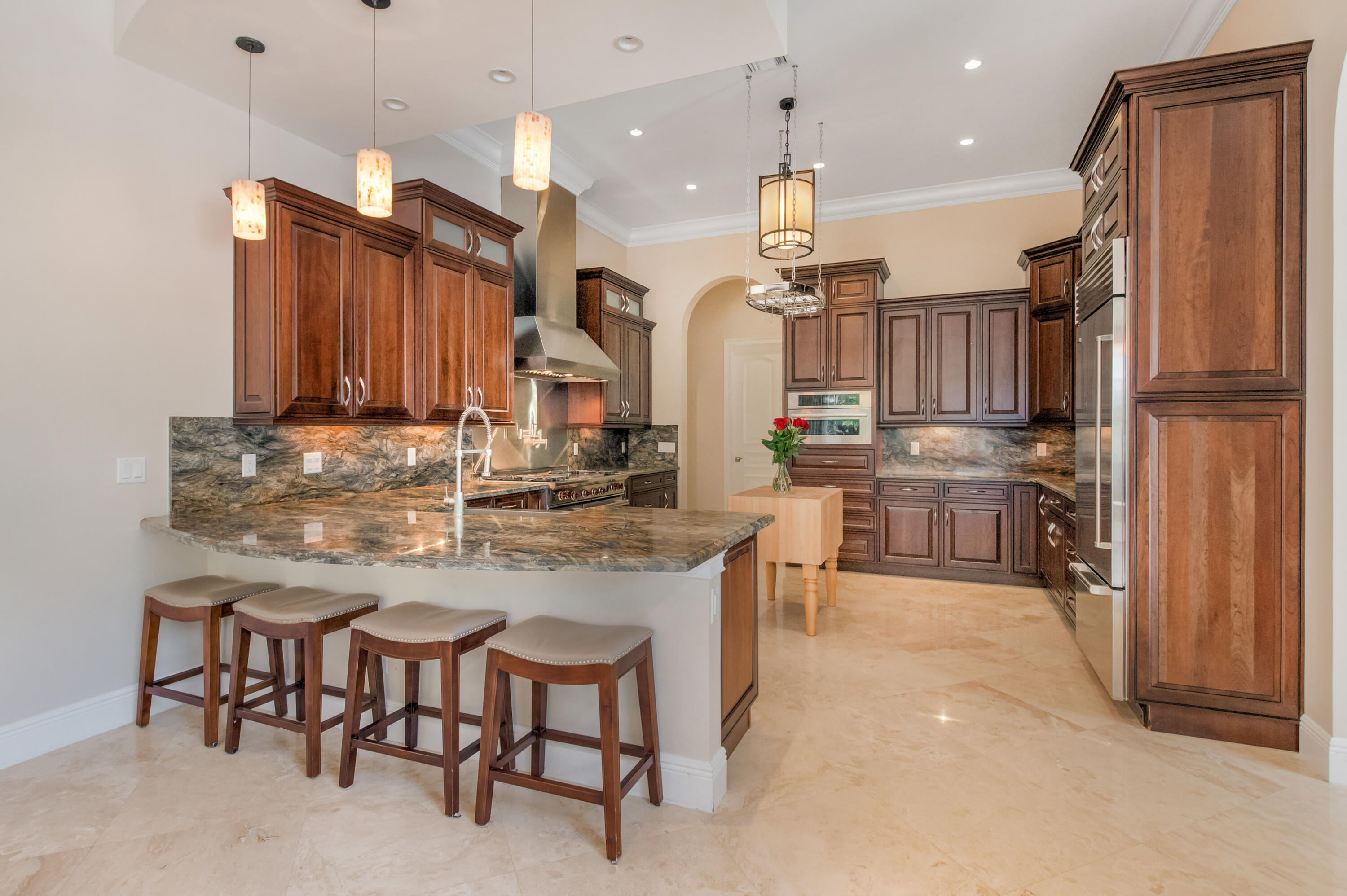 1130 Spanish River Road Boca Raton, FL 33432 - Photo 6 of 59 a kitchen with stainless steel appliances kitchen island granite countertop a table chairs sink and cabinets