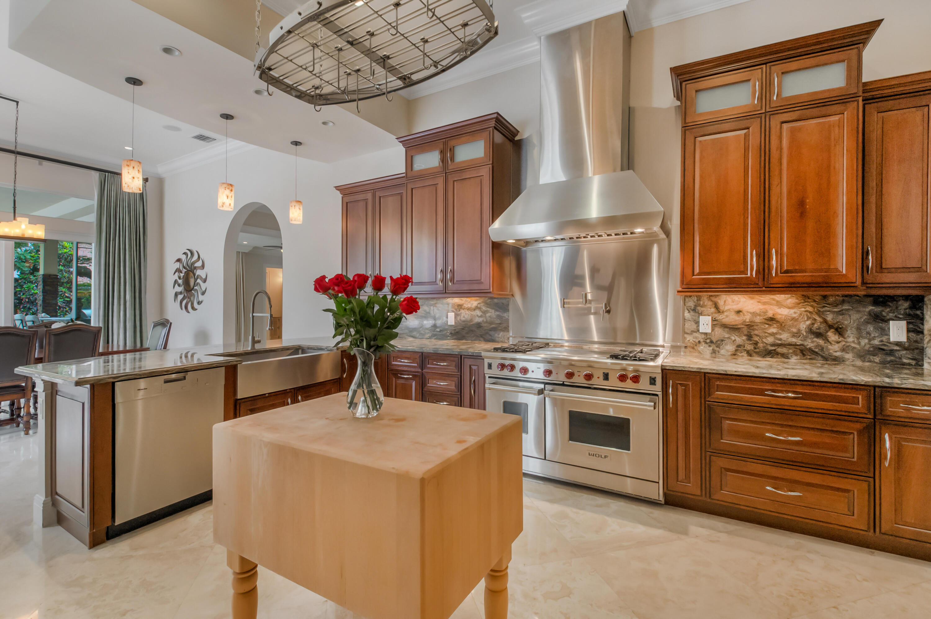 1130 Spanish River Road Boca Raton, FL 33432 - Photo 8 of 59 a kitchen with stainless steel appliances a stove a chimney a sink and cabinets