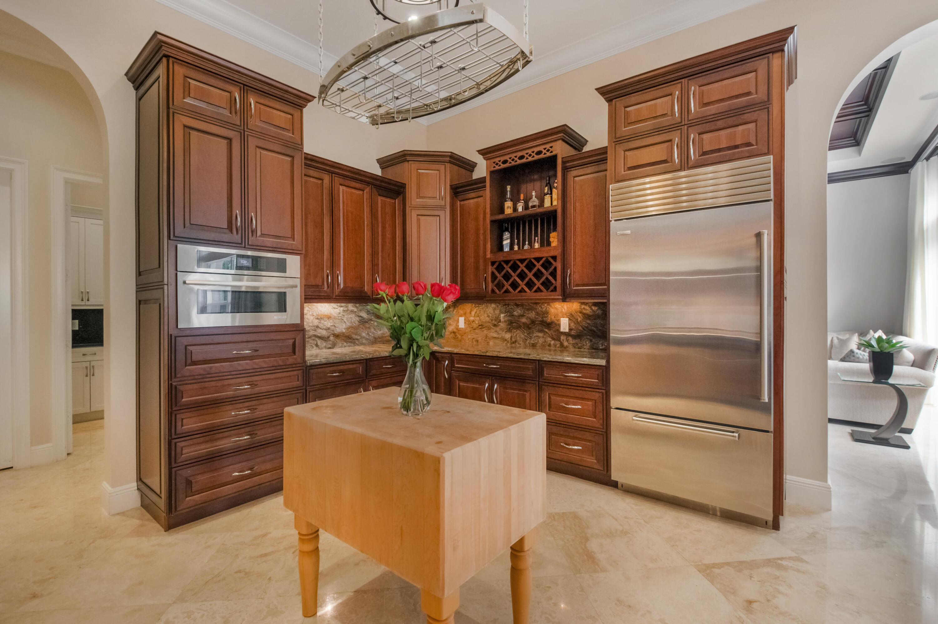 1130 Spanish River Road Boca Raton, FL 33432 - Photo 10 of 59 a kitchen with a refrigerator and cabinets