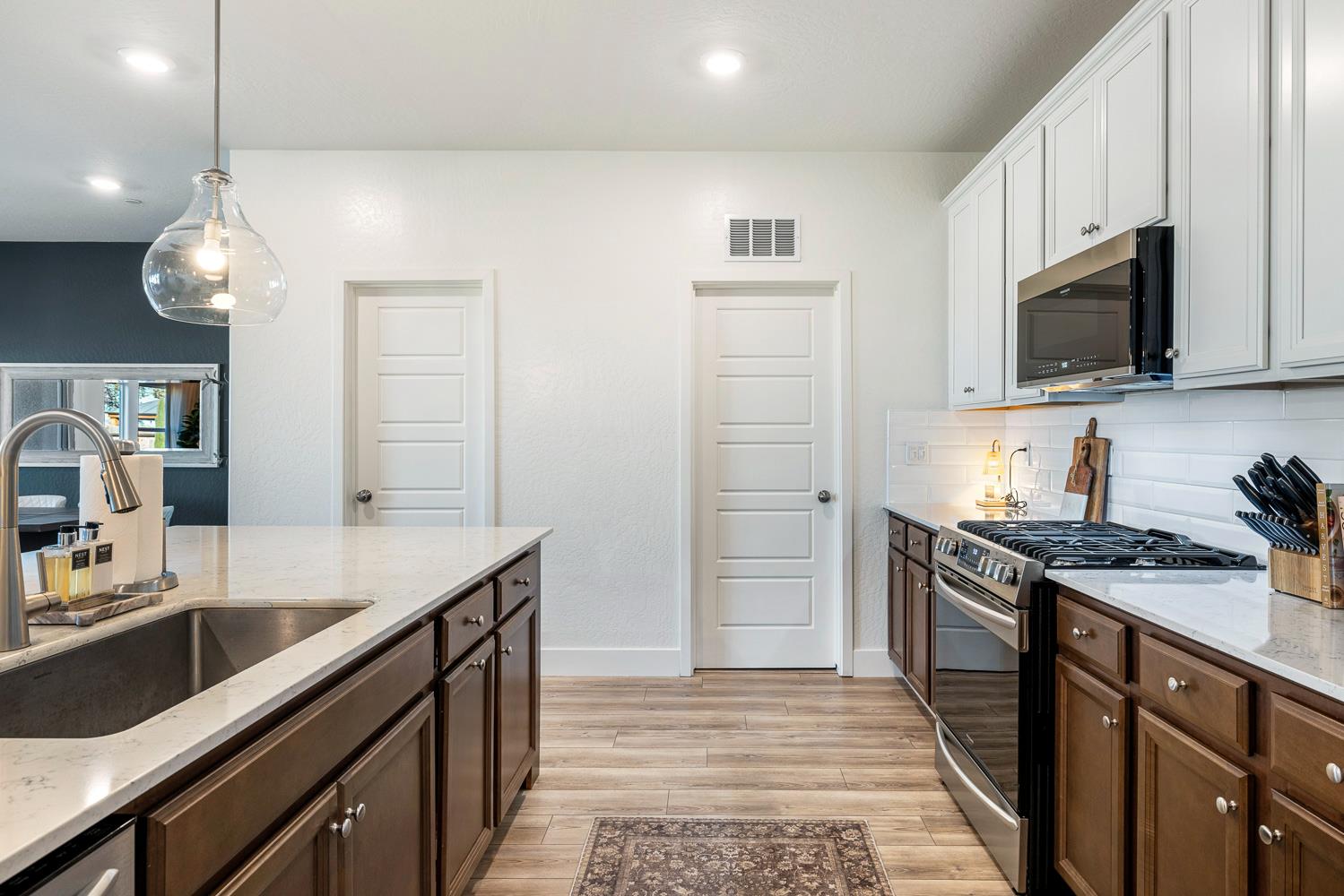 601 Wishon Avenue Madera, CA 93636 - Photo 12 of 33 a kitchen with stainless steel appliances granite countertop a sink a stove and a refrigerator