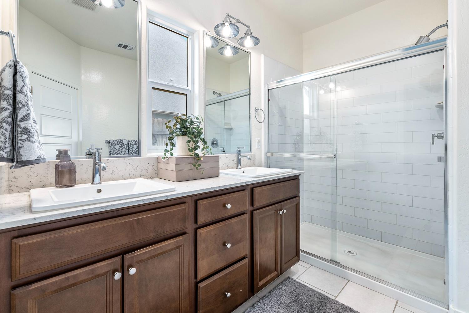 601 Wishon Avenue Madera, CA 93636 - Photo 21 of 33 a bathroom with a double vanity sink mirror and shower