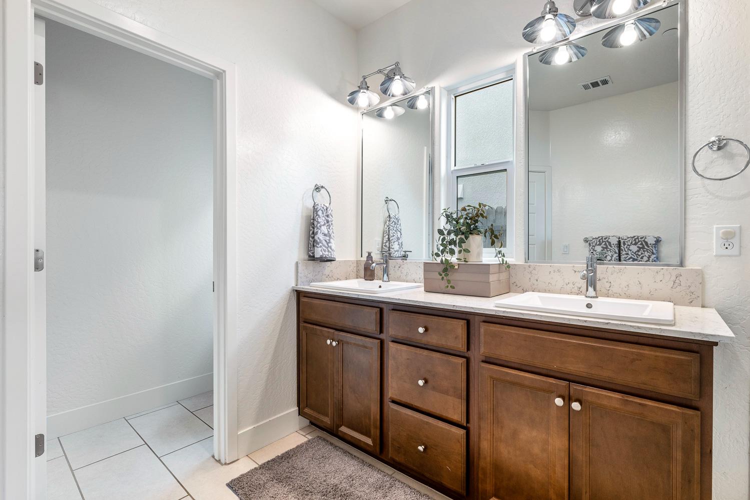 601 Wishon Avenue Madera, CA 93636 - Photo 23 of 33 a bathroom with a double vanity sink and a mirror