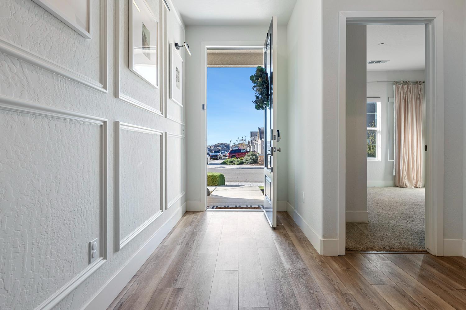 601 Wishon Avenue Madera, CA 93636 - Photo 24 of 33 a view of a hallway and a livingroom with wooden floor