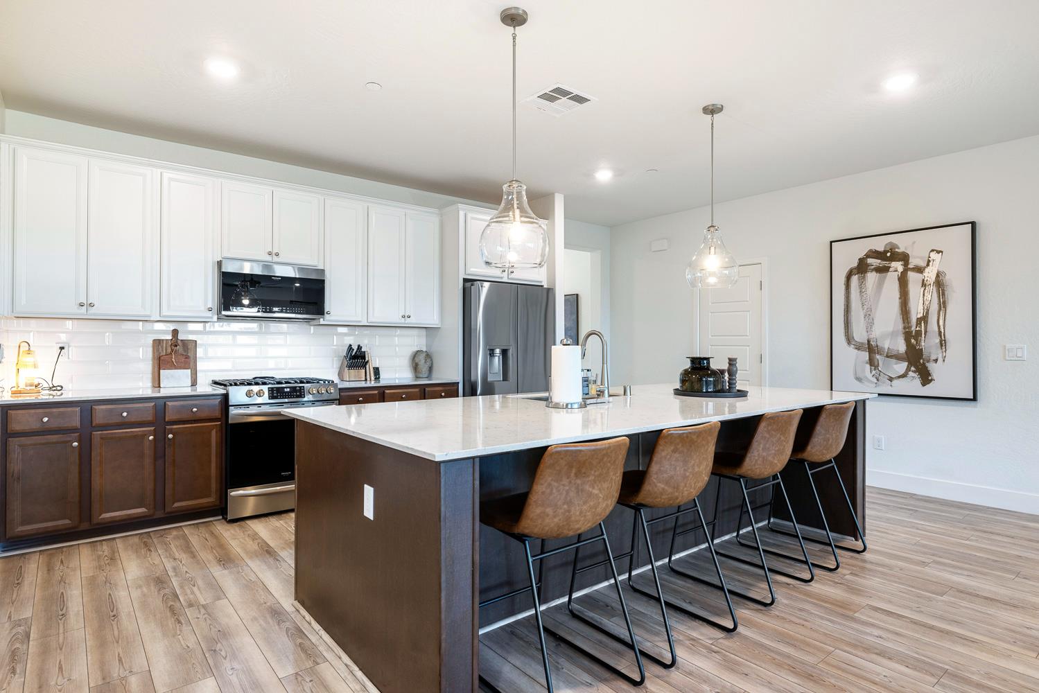 601 Wishon Avenue Madera, CA 93636 - Photo 8 of 33 a kitchen with stainless steel appliances granite countertop a sink a stove a refrigerator cabinets and chairs
