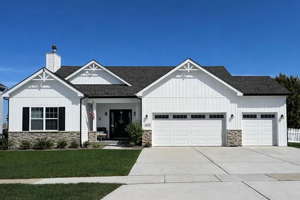 a front view of a house with a yard and garage