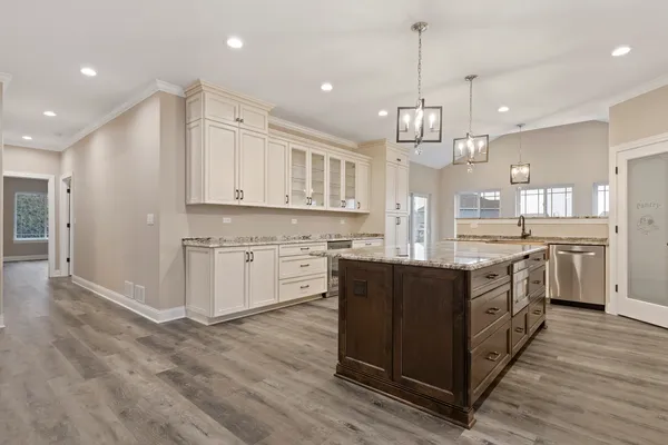 a kitchen with stainless steel appliances granite countertop a sink and cabinets