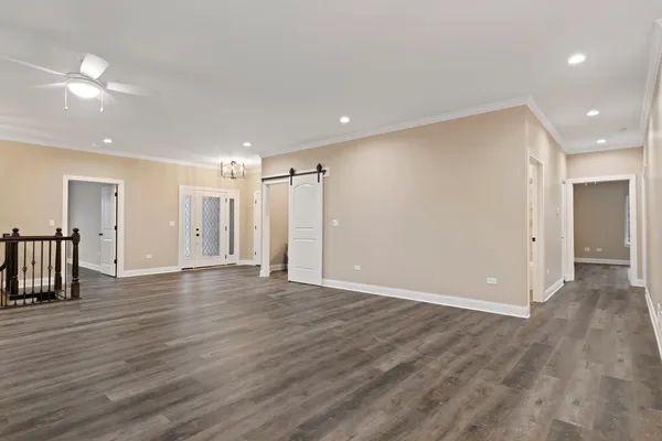 a view of an empty room with wooden floor