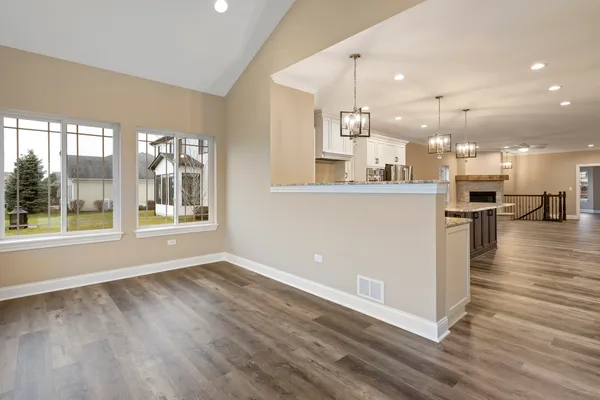 a view of a kitchen with wooden floor and a window