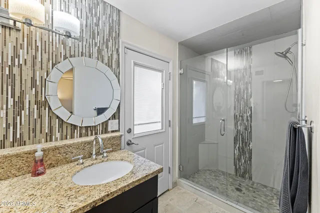 a bathroom with a double vanity sink and a mirror