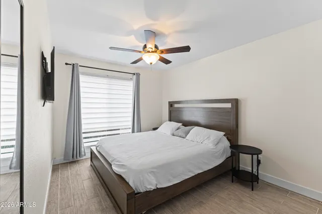 a bathroom with a granite countertop sink toilet a mirror a bathtub and shower