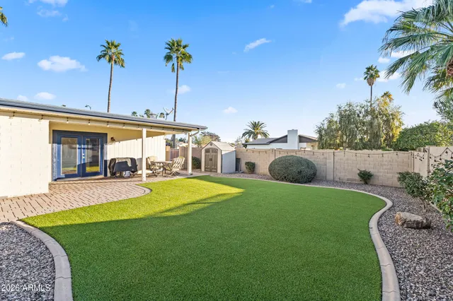 a bedroom with two bed and a large window