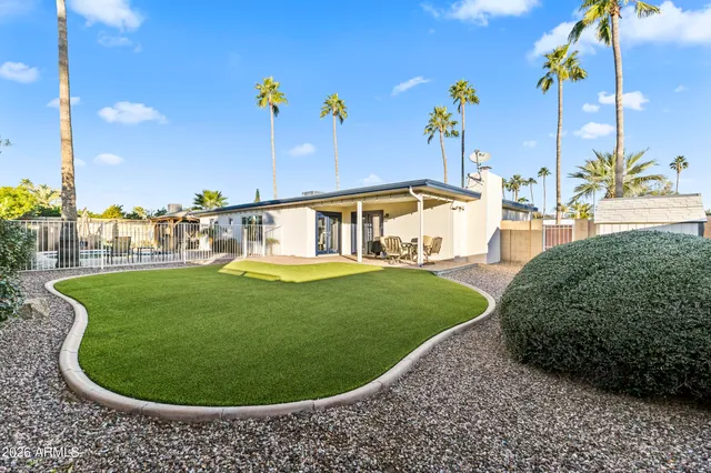 a view of a house with swimming pool and sitting area