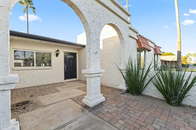 a view of a patio with table and chairs under an umbrella with wooden floor