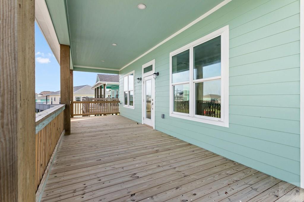 971 Tidelands Crystal Beach, TX 77650 - Photo 12 of 38 a hallway with wooden floor and furniture