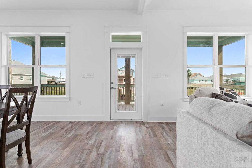971 Tidelands Crystal Beach, TX 77650 - Photo 16 of 38 a view of an empty room with wooden floor and a window