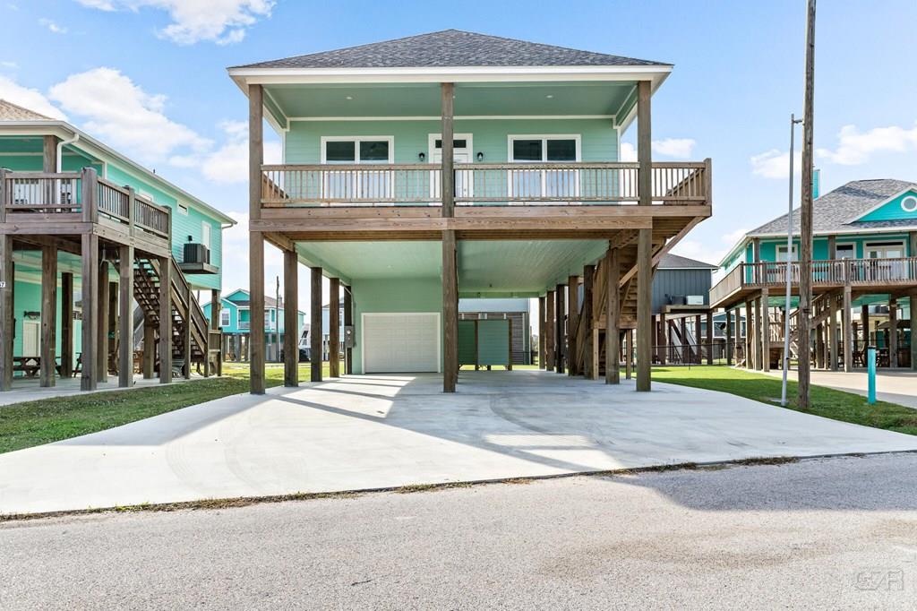 971 Tidelands Crystal Beach, TX 77650 - Photo 2 of 38 a view of a building with a yard