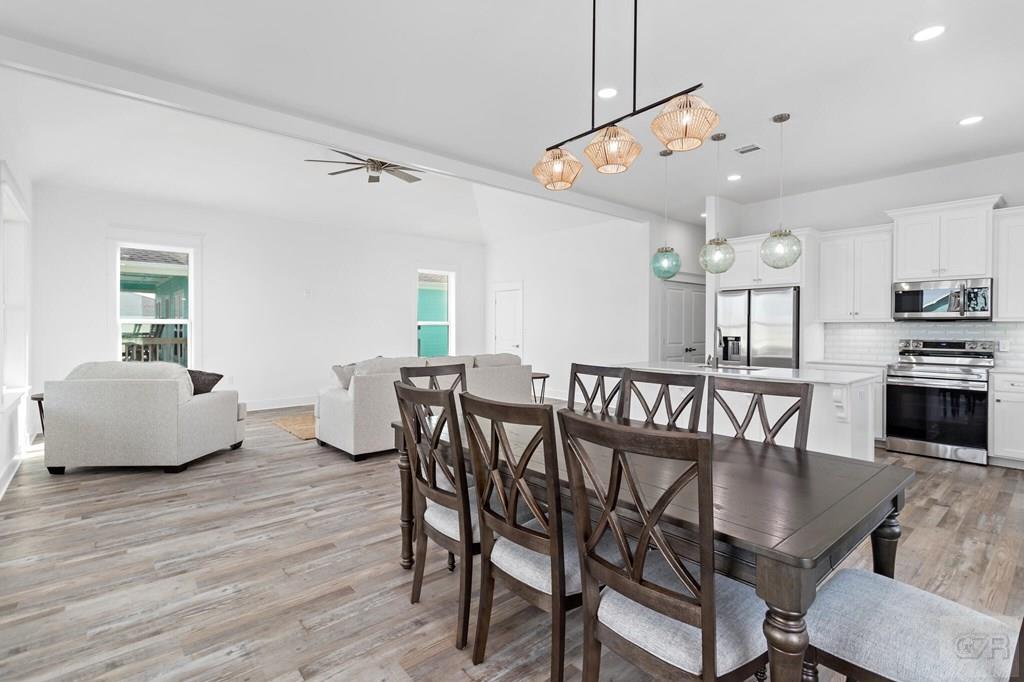 971 Tidelands Crystal Beach, TX 77650 - Photo 21 of 38 a view of a dining room with furniture and wooden floor