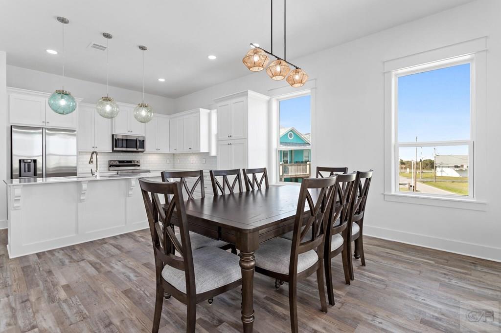 971 Tidelands Crystal Beach, TX 77650 - Photo 22 of 38 a view of a dining room with furniture and wooden floor