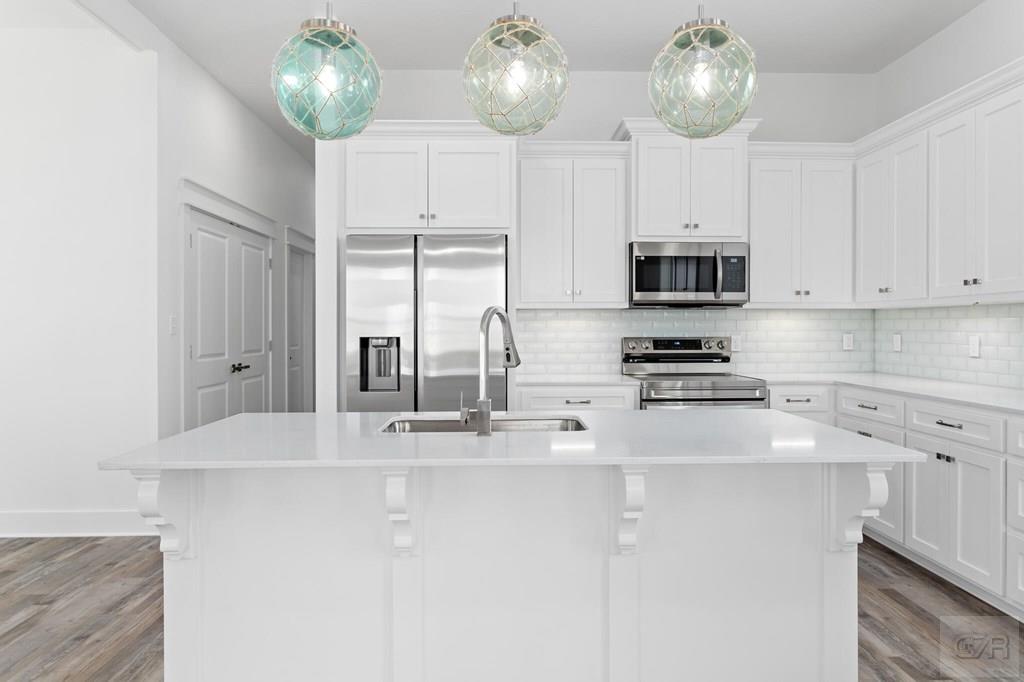 971 Tidelands Crystal Beach, TX 77650 - Photo 23 of 38 a kitchen with stainless steel appliances cabinets a refrigerator and a sink