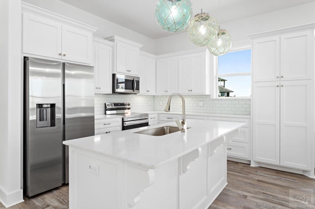 971 Tidelands Crystal Beach, TX 77650 - Photo 24 of 38 a kitchen with kitchen island a sink stove and refrigerator